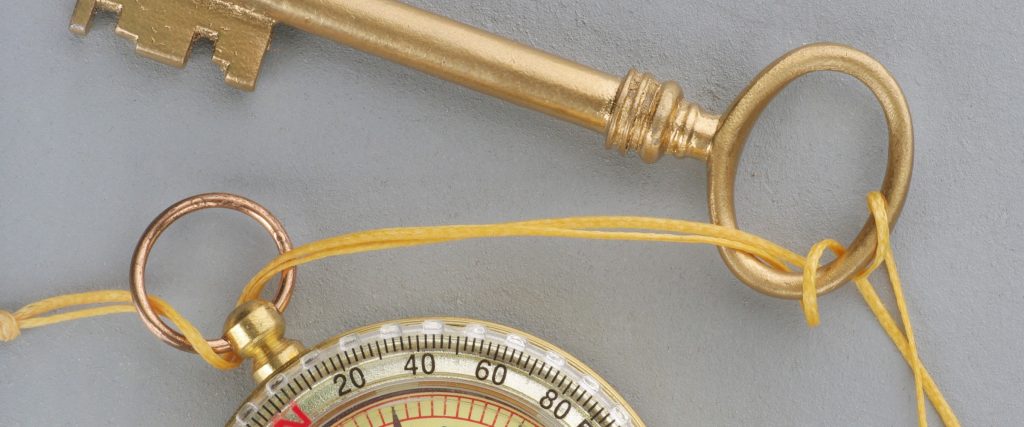header - Vintage golden key with compass